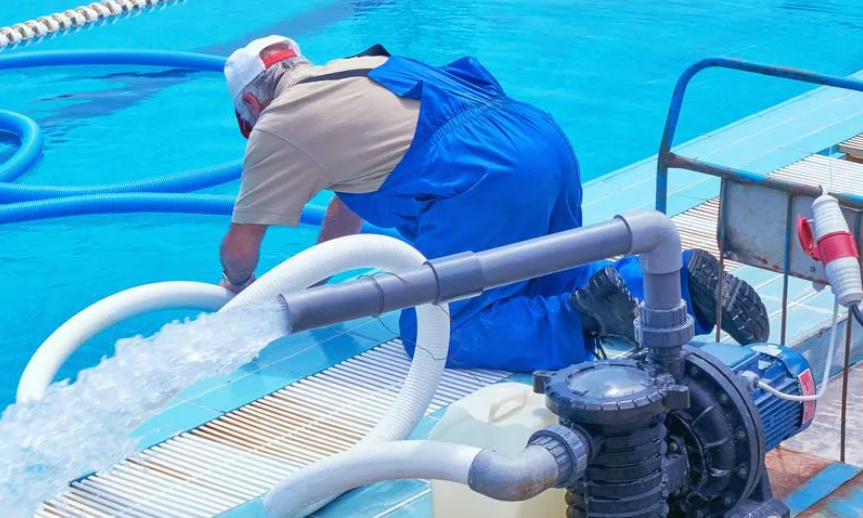 Pool technician cleaning pool